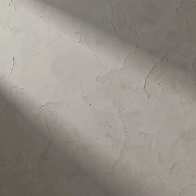 a plain plaster wall with subtle shadows