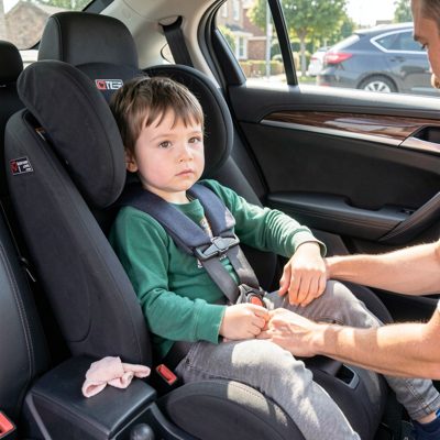 a car seat being fitted for a child