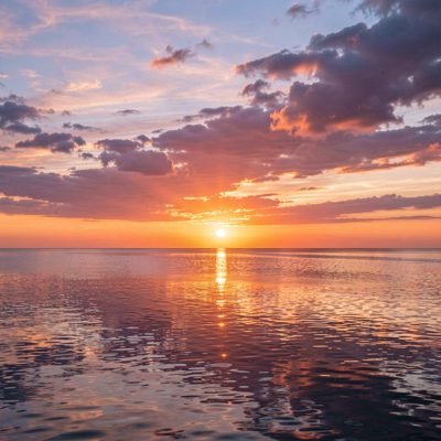 a sunset over a calm sea
