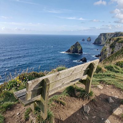 a sea view from a clifftop bench