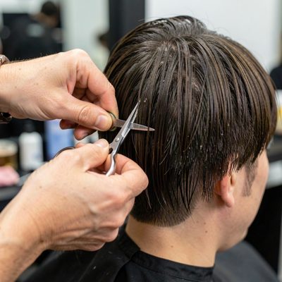 a stylist cutting into a fringe with precision