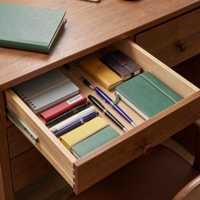 a desk drawer open showing neatly arranged stationery