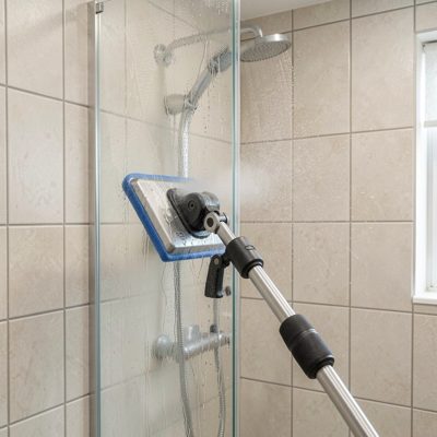 a steam cleaner being used on a shower screen