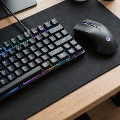 a mechanical keyboard and mouse on a desk mat
