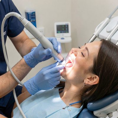dentist using curing light on new filling