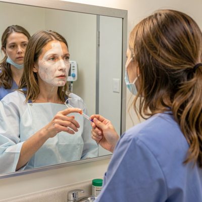 post-surgery patient reviewing reflection in mirror