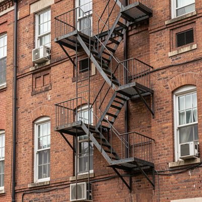a fire escape zigzagging down a brick facade