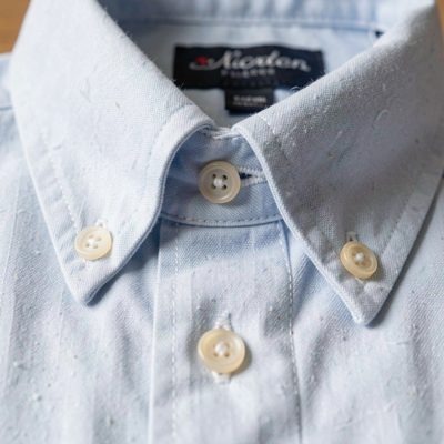 a shirt collar and buttons photographed close