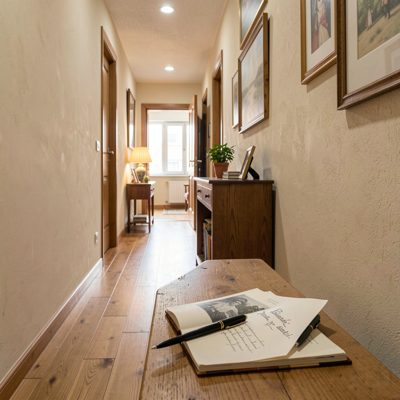 a hallway with a visitor book and pen