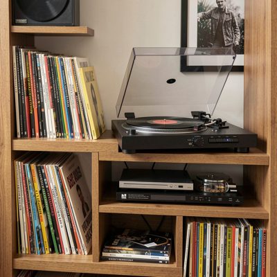 a shelf of vinyl records and a turntable