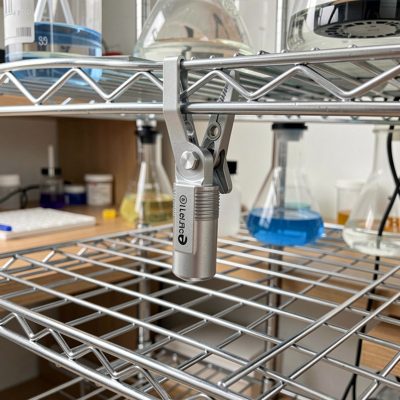 a temperature sensor clipped to a home lab rack