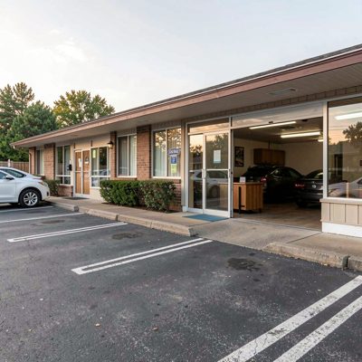 a roadside motel with doors opening onto the car park