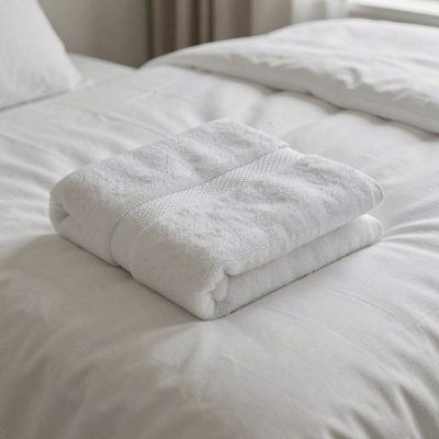 a folded towel shaped and placed on a bed