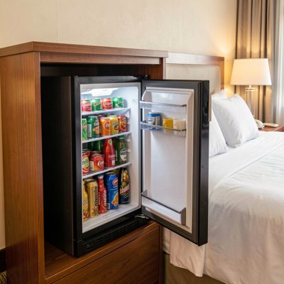 a mini bar fridge open in a hotel room