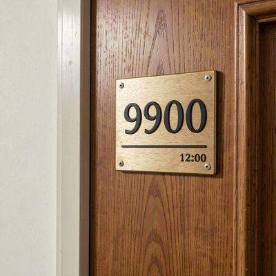 a room number plate beside a door