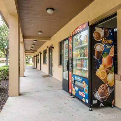 a vending machine in a covered motel walkway