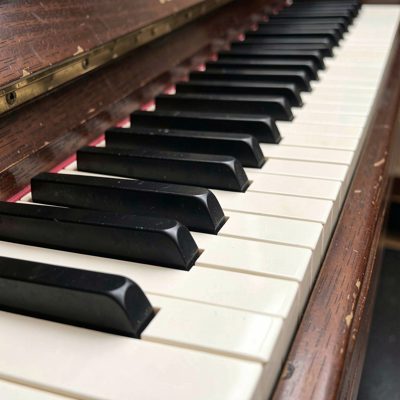 a piano keyboard photographed close along the keys