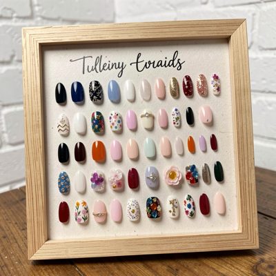 a display of press on nail samples on a board