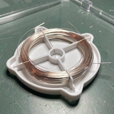 a fibre splice tray with neat loops of bare fibre