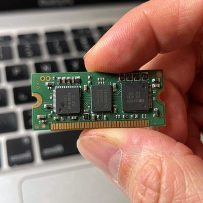 a laptop so-dimm module held between finger and thumb