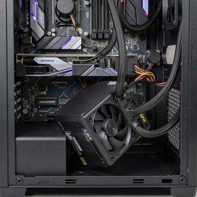 a psu being lowered into the bottom of a pc case
