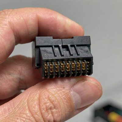 a 24 pin atx connector held in a hand