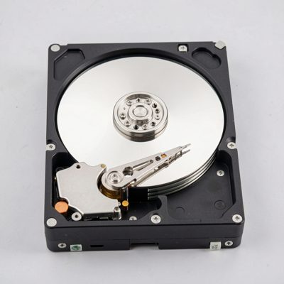 a 3.5 inch hard drive with its top cover removed showing the platter and arm