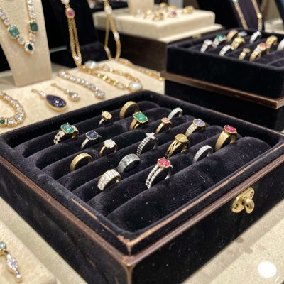 a jewelry display with rings on a velvet tray