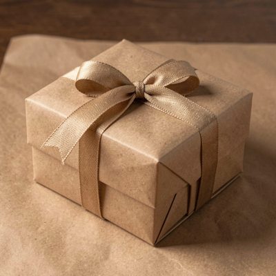 a boxed gift with ribbon tied on brown paper