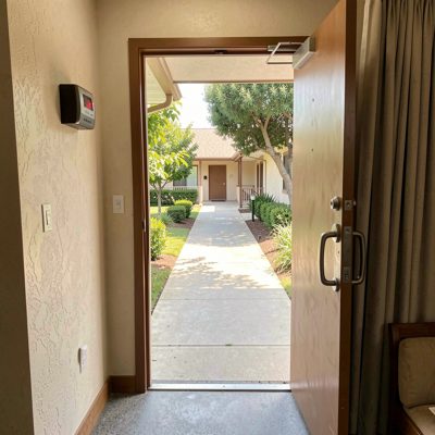 a motel room door opening onto a walkway