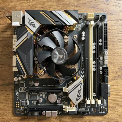 a motherboard with a cpu cooler photographed from above
