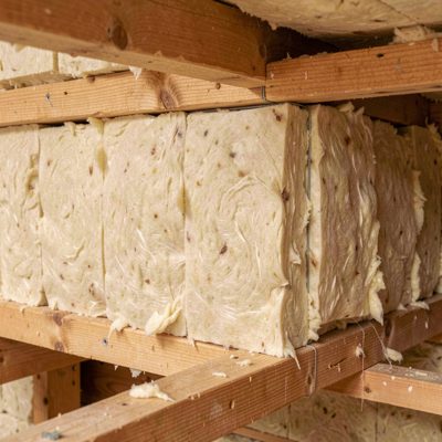 an insulation batt being fitted between joists