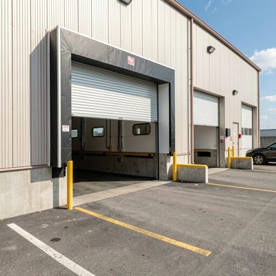 a loading dock with roller shutters open