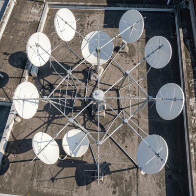 a rooftop antenna array photographed from directly below