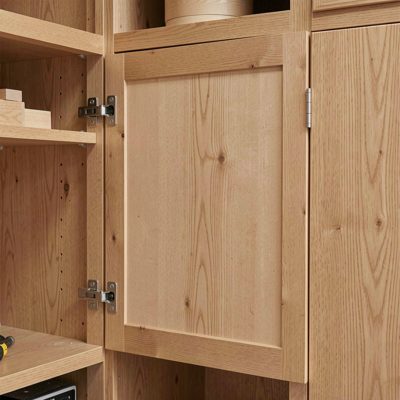 a cabinet door being fitted with hinges